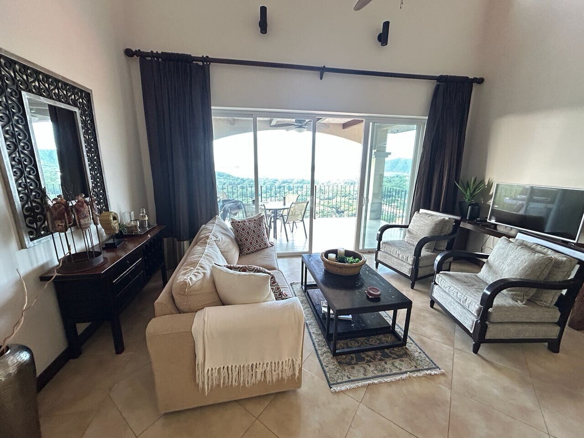 A402 living room with sofa, chairs, and balcony view